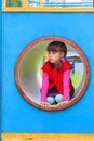 Pretty little girl lies in pipe on playground Royalty Free Stock Photo