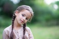 Pretty little girl with long brown hair and beautiful dirty face posing summer nature outdoor. Orphan, child of war, poor Royalty Free Stock Photo