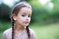 Pretty little girl with long brown hair and beautiful dirty face posing summer nature outdoor. Orphan, child of war, poor Royalty Free Stock Photo