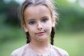 Pretty little girl with long brown hair and beautiful dirty face posing summer nature outdoor. Orphan, child of war, poor Royalty Free Stock Photo