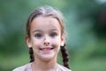 Pretty little girl with long brown hair and beautiful dirty face posing summer nature outdoor. Orphan, child of war, poor Royalty Free Stock Photo