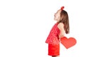 Pretty little girl with long hair hold red paper heart in hands behind back  on white background. Profile shot. Royalty Free Stock Photo