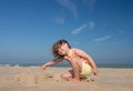Pretty little girl making sandcastles on the beaches of Hauts-de-France Royalty Free Stock Photo