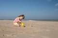 Pretty little girl making sandcastles on the beaches of Hauts-de-France Royalty Free Stock Photo