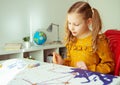 Pretty little girl paiting with colorful  crayon and paintbrush Royalty Free Stock Photo