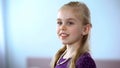 Pretty little girl with pearl necklace looking in mirror, enjoying reflection Royalty Free Stock Photo