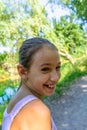 Pretty little girl picking a flower on a path surrounded by nature