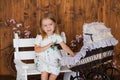Pretty little girl play with retro pram, baby stroller Royalty Free Stock Photo