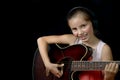 A pretty little girl playing guitar Royalty Free Stock Photo
