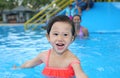 Pretty little girl playing in swimming pool outdoors Royalty Free Stock Photo