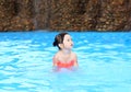 Pretty little girl playing in swimming pool outdoors Royalty Free Stock Photo