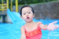 Pretty little girl playing in swimming pool outdoors Royalty Free Stock Photo