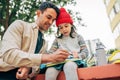 A pretty little girl in a red cap drawing with her dad outdoor after school. Father enjoying the time together with his child Royalty Free Stock Photo