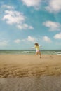 Pretty little girl running on the beaches of Hauts-de-France Royalty Free Stock Photo