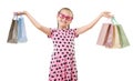 Pretty little girl with shopping bag, studio portrait, dressed in pink with heart shapes, white background Royalty Free Stock Photo