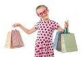 Pretty little girl with shopping bag, studio portrait, dressed in pink with heart shapes, white background Royalty Free Stock Photo