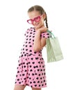 Pretty little girl with shopping bag, studio portrait, dressed in pink with heart shapes, white background Royalty Free Stock Photo