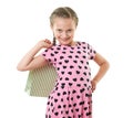 Pretty little girl with shopping bag, studio portrait, dressed in pink with heart shapes, white background Royalty Free Stock Photo