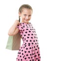 Pretty little girl with shopping bag, studio portrait, dressed in pink with heart shapes, white background Royalty Free Stock Photo