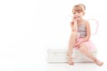 Pretty little girl sitting on case Royalty Free Stock Photo