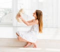 Liittle girl sitting on the floor and holding Teddy bear toy Royalty Free Stock Photo