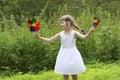 Pretty little girl with two windmills spins Royalty Free Stock Photo