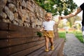 Pretty little girl walking on the bench with help of mother s hand Royalty Free Stock Photo