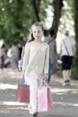 Pretty little girl walking with the pink shopping bags Royalty Free Stock Photo