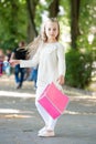 Pretty little girl walking with the pink shopping bags Royalty Free Stock Photo