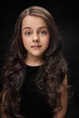 Pretty, little girl in black dress posing. Royalty Free Stock Photo