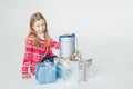 Pretty little girl wearing Christmas sweater sitting isolated on white background, holding stack of present boxes.Merry Royalty Free Stock Photo