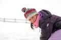 Pretty little girl with wool beret playing on snow in the winter Royalty Free Stock Photo