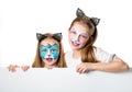 Little girls with face arts holding a sheet for your adverisement or text isolated Royalty Free Stock Photo