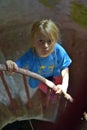 Pretty Little girls on stone spiral staircase an old Royalty Free Stock Photo