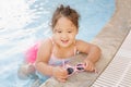 Kazakh little girl playing near swimming pool