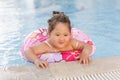 Kazakh little girl playing near swimming pool