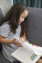 Pretty little kazakh girl reading a book