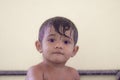 Pretty little kid boy with wet hair is sitting alone and looking at camera, Portrait of little asian child Royalty Free Stock Photo