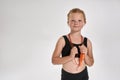 Pretty little red haired sportive girl in earphones smiling at camera, standing with jump rope while posing isolated Royalty Free Stock Photo