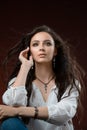 Pretty long brown hair girl model wearing luxury silver accessory and jewelry. Woman Isolated on brown background