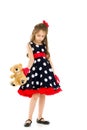 Pretty Long Haired Girl Wearing Polka Dot Dress Posing with Teddy Bear Royalty Free Stock Photo