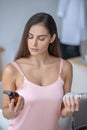 Pretty long-haired woman choosing beauty products Royalty Free Stock Photo