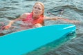 Pretty long-haired woman wakeboarder floating in the river Royalty Free Stock Photo