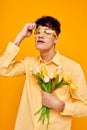 pretty man with a fashionable hairstyle in yellow shirts with flowers holiday unaltered Royalty Free Stock Photo