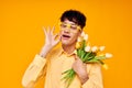 pretty man with a fashionable hairstyle in yellow shirts with flowers holiday unaltered Royalty Free Stock Photo