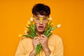 pretty man with a fashionable hairstyle in yellow shirts with flowers holiday unaltered Royalty Free Stock Photo
