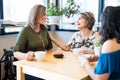 Woman receiving birthday wishes from friends at cafe Royalty Free Stock Photo