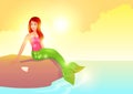 Pretty mermaid sitting on the rock during sunset Royalty Free Stock Photo