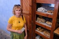 Pretty middle-aged woman near cakes sale in blue city of  Chefchaouen,Morocco Royalty Free Stock Photo