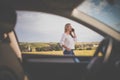 Pretty midle aged woman  having a break on a long trip, making a phone call Royalty Free Stock Photo